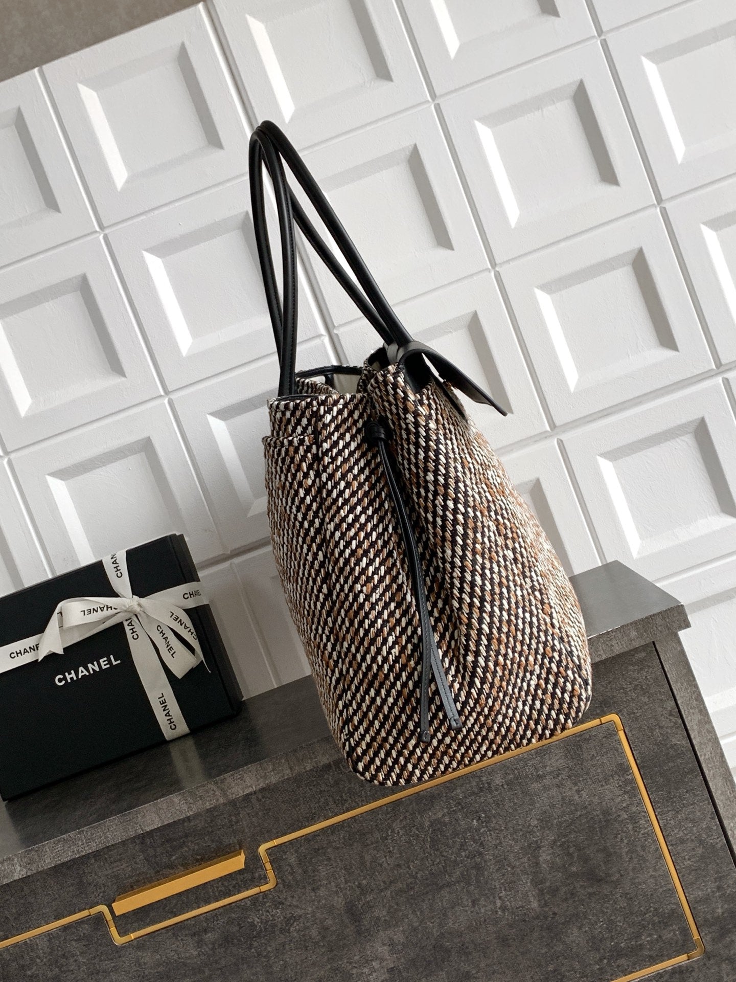 Black and multicolor tweed handbag on side view with long black handles