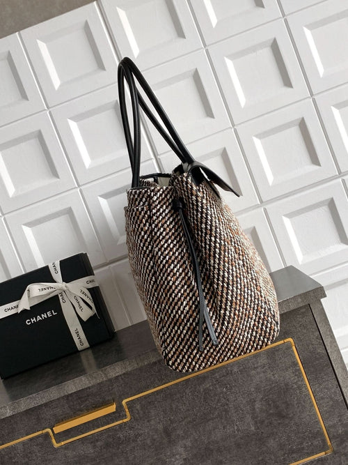 Black and multicolor tweed handbag on side view with long black handles