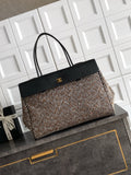 Black and multicolor tweed handbag with black top handles and front clasp detail