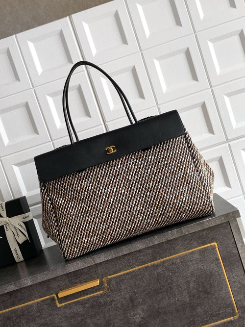Black and multicolor tweed handbag with black top handles and front clasp detail