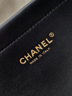 Chanel logo and “MADE IN ITALY” on black leather handbag panel