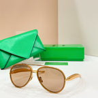 Round sunglasses with gold frames and tan-tinted lenses