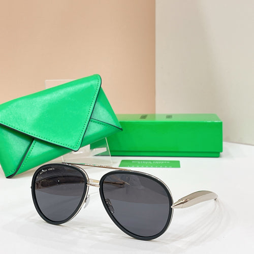 Round sunglasses with black frames and dark tinted lenses