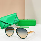Round sunglasses with dark green frames and amber-tinted lenses