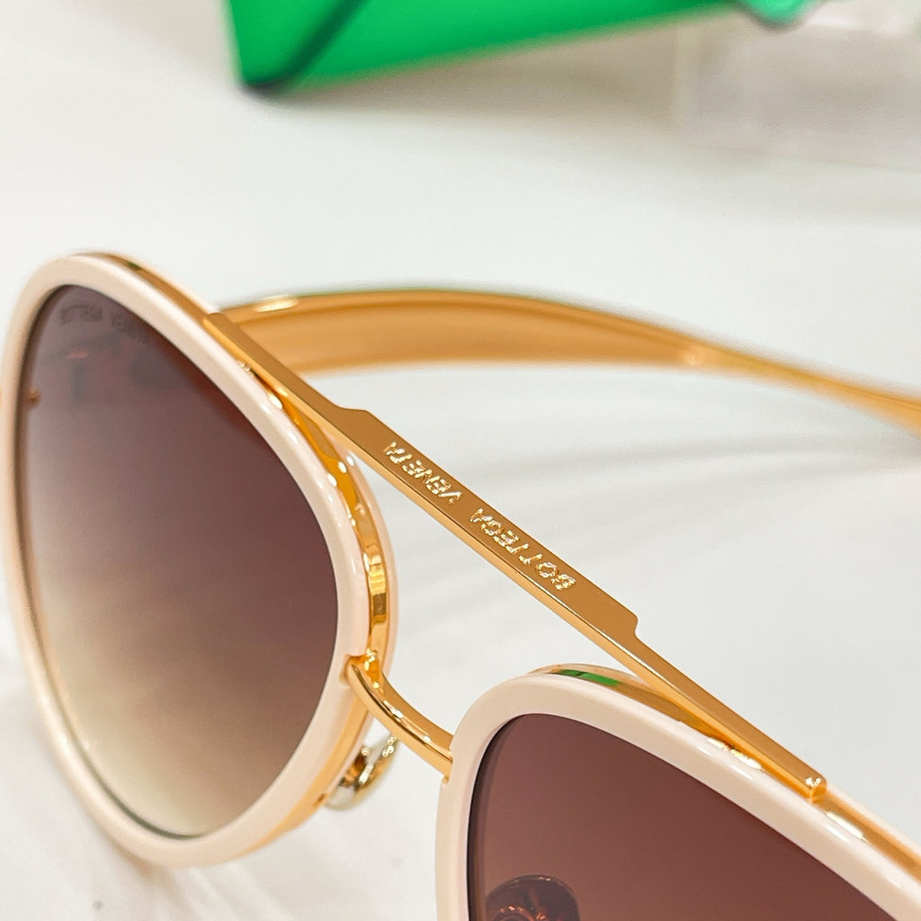 Close-up of round sunglasses with cream frames and brown tinted lenses