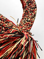 Chanel fringe handbag corner with red, black, and cream tassel threads