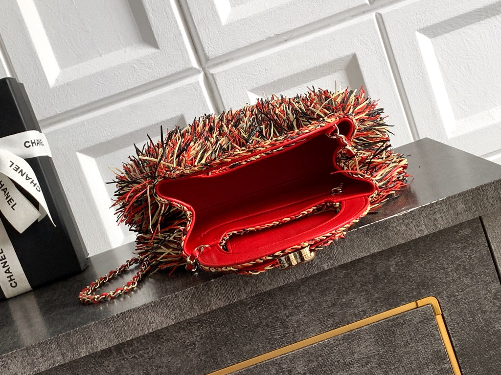 Chanel fringe handbag with open red interior and chain strap