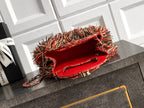 Chanel fringe handbag with open red interior and chain strap
