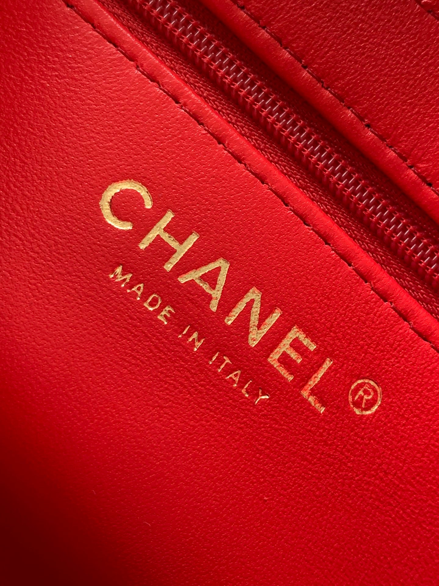Chanel red leather patch with CHANEL, Made in Italy, and logo stamp