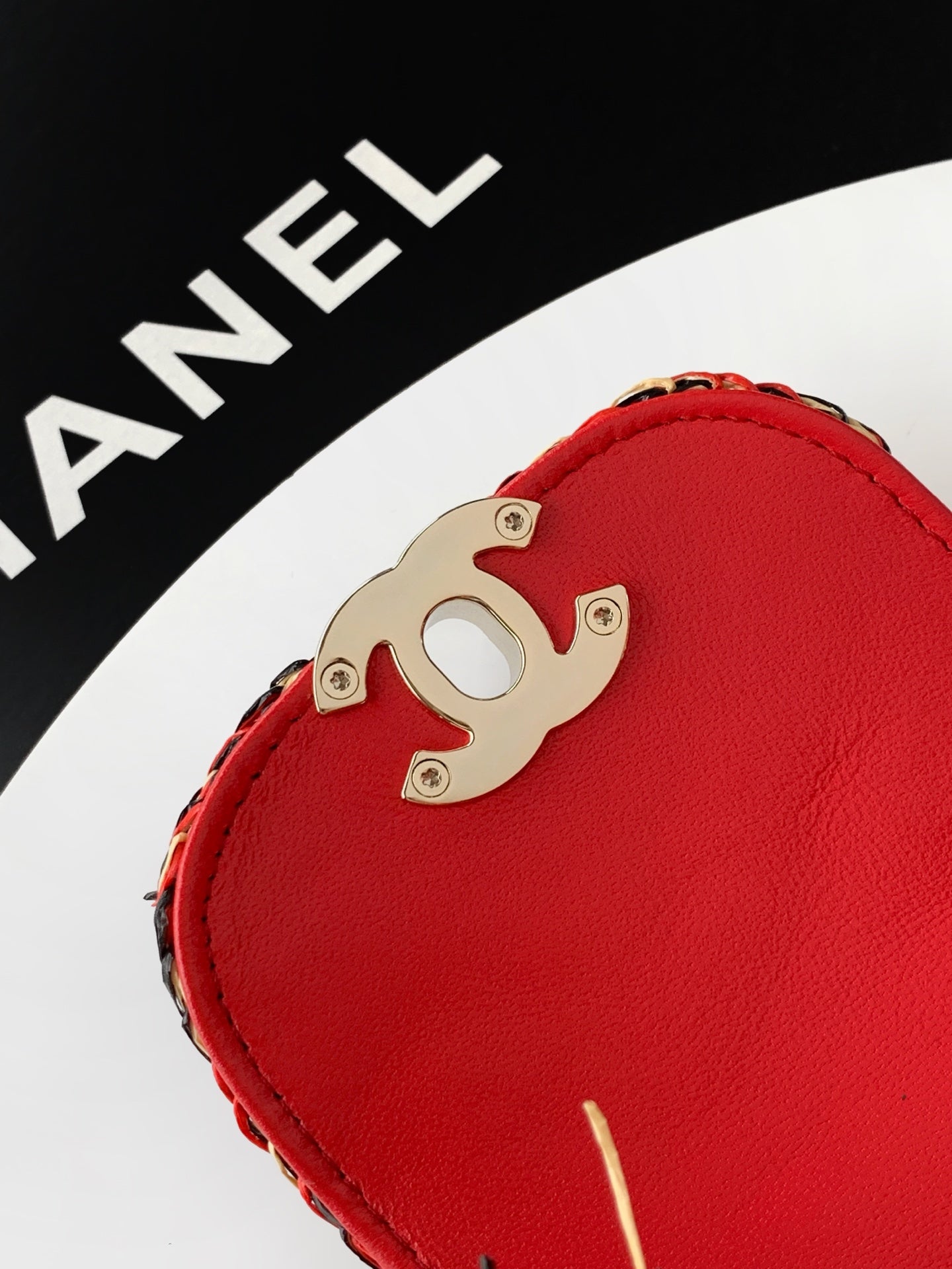 Chanel red leather handbag with metal CC logo on front hardware