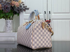 Louis Vuitton Damier checkered handbag angled view with braided top handles