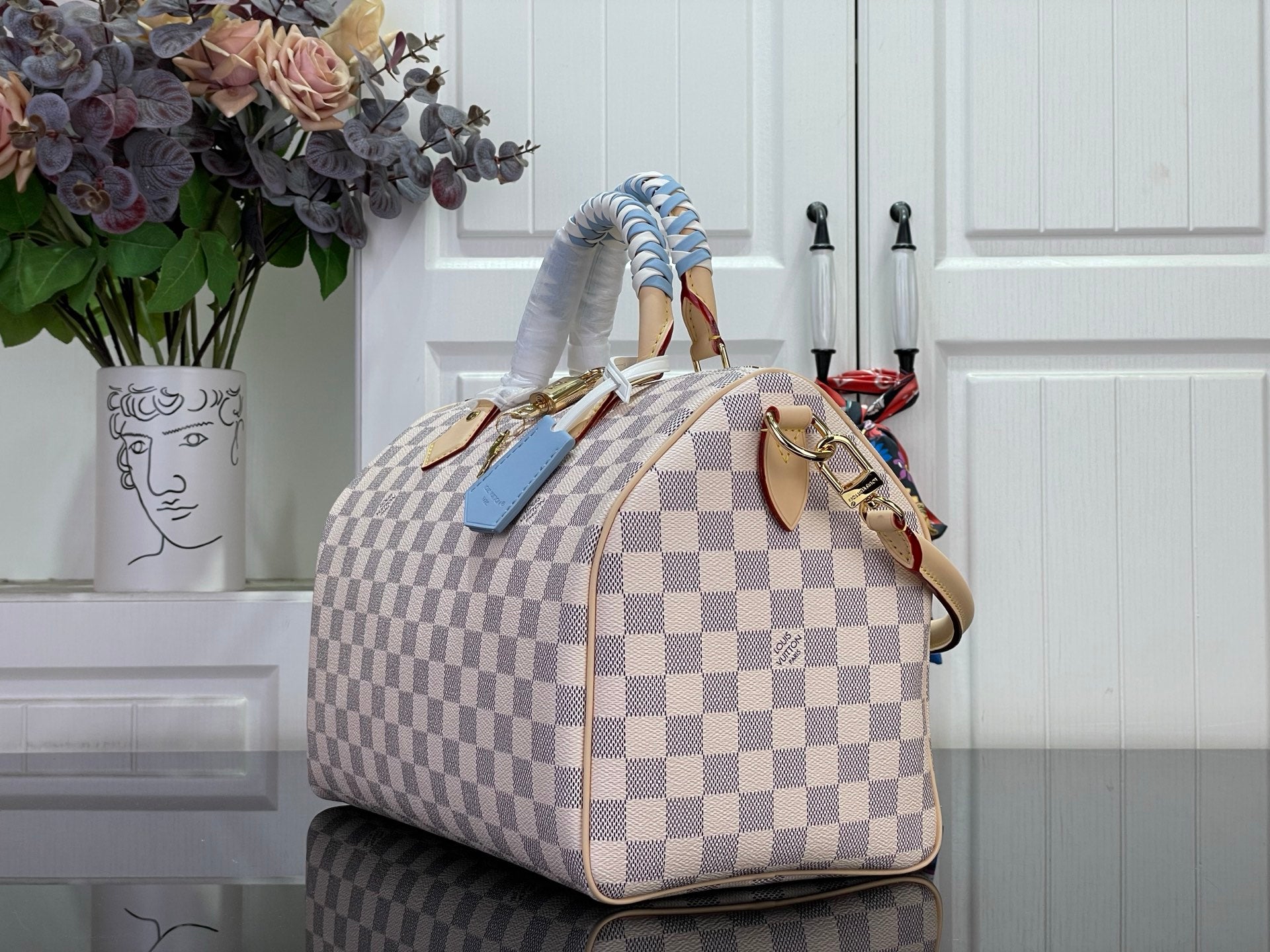 Louis Vuitton Damier checkered handbag angled view with braided top handles