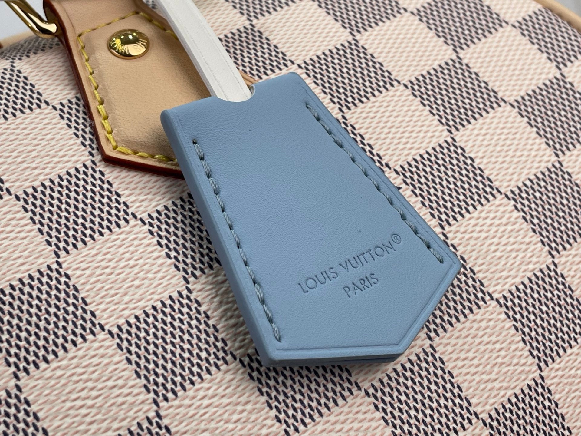 Louis Vuitton Damier handbag blue leather charm with stitched edge and logo text
