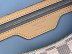 Louis Vuitton Paris label on light blue leather bag with gold zipper and stitched trim
