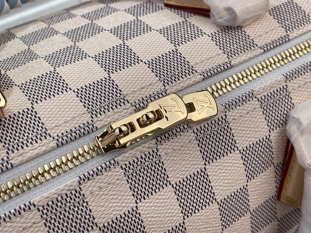 Louis Vuitton Damier handbag zipper close-up with gold-tone hardware