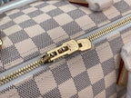 Louis Vuitton Damier handbag zipper close-up with gold-tone hardware