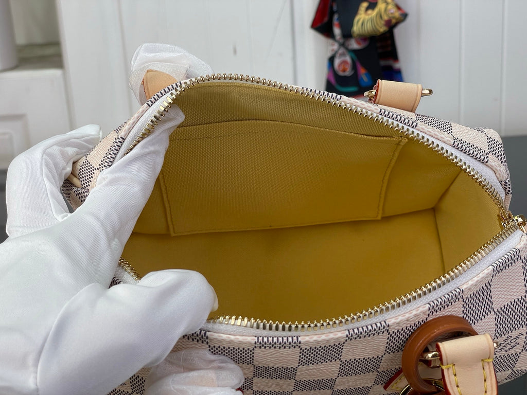 Louis Vuitton Damier check bag interior with gold-tone zipper and tan leather trim