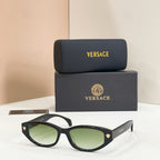 Versace sunglasses with black frames and green gradient lenses