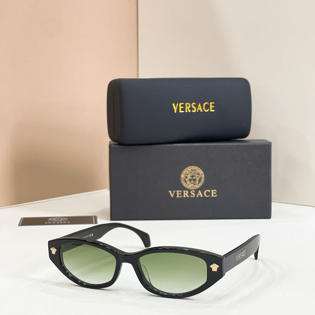 Versace sunglasses with black frames and green gradient lenses