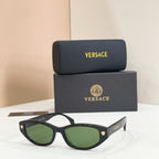 Versace sunglasses with matte black frames and green gradient lenses