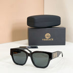 Black sunglasses with square frames and dark green tinted lenses