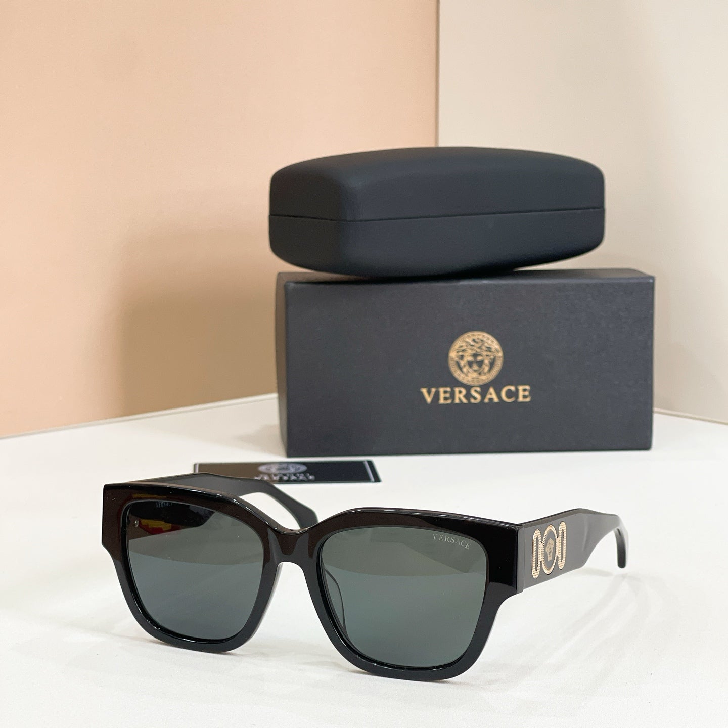 Black sunglasses with square frames and dark green tinted lenses