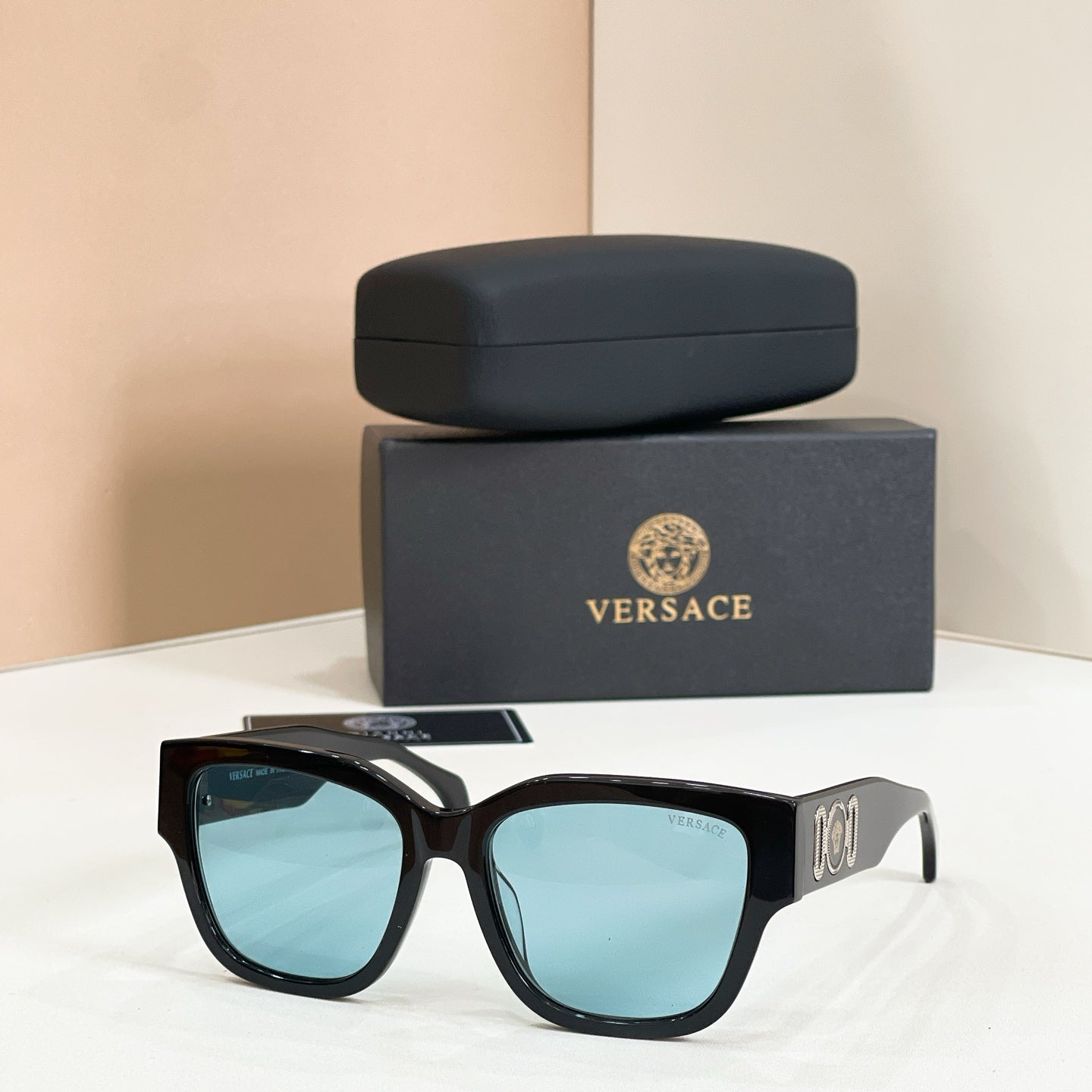 Black sunglasses with square frames and light-blue mirrored lenses