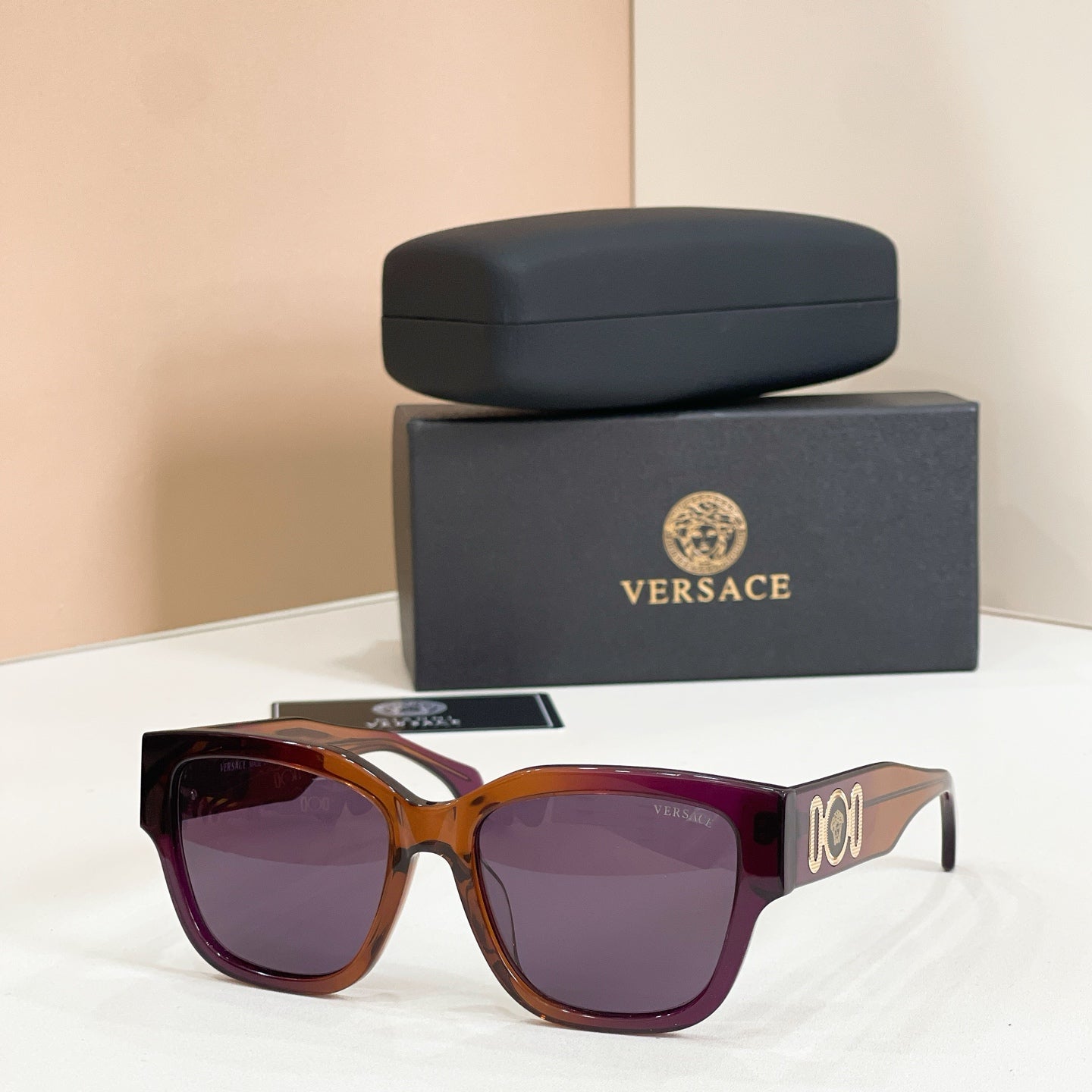 Tortoiseshell sunglasses with square frames and dark purple tinted lenses