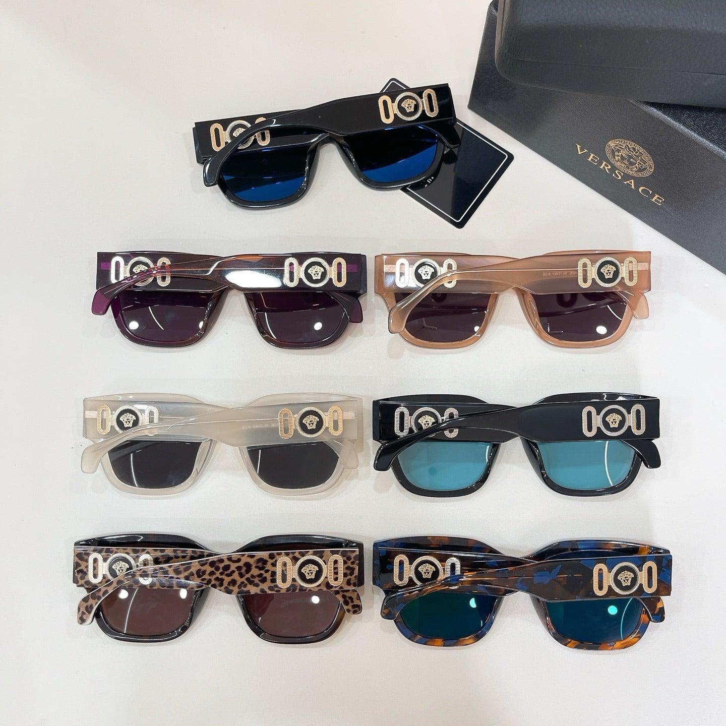 Close-up of assorted square sunglasses with varied frames and tinted lenses