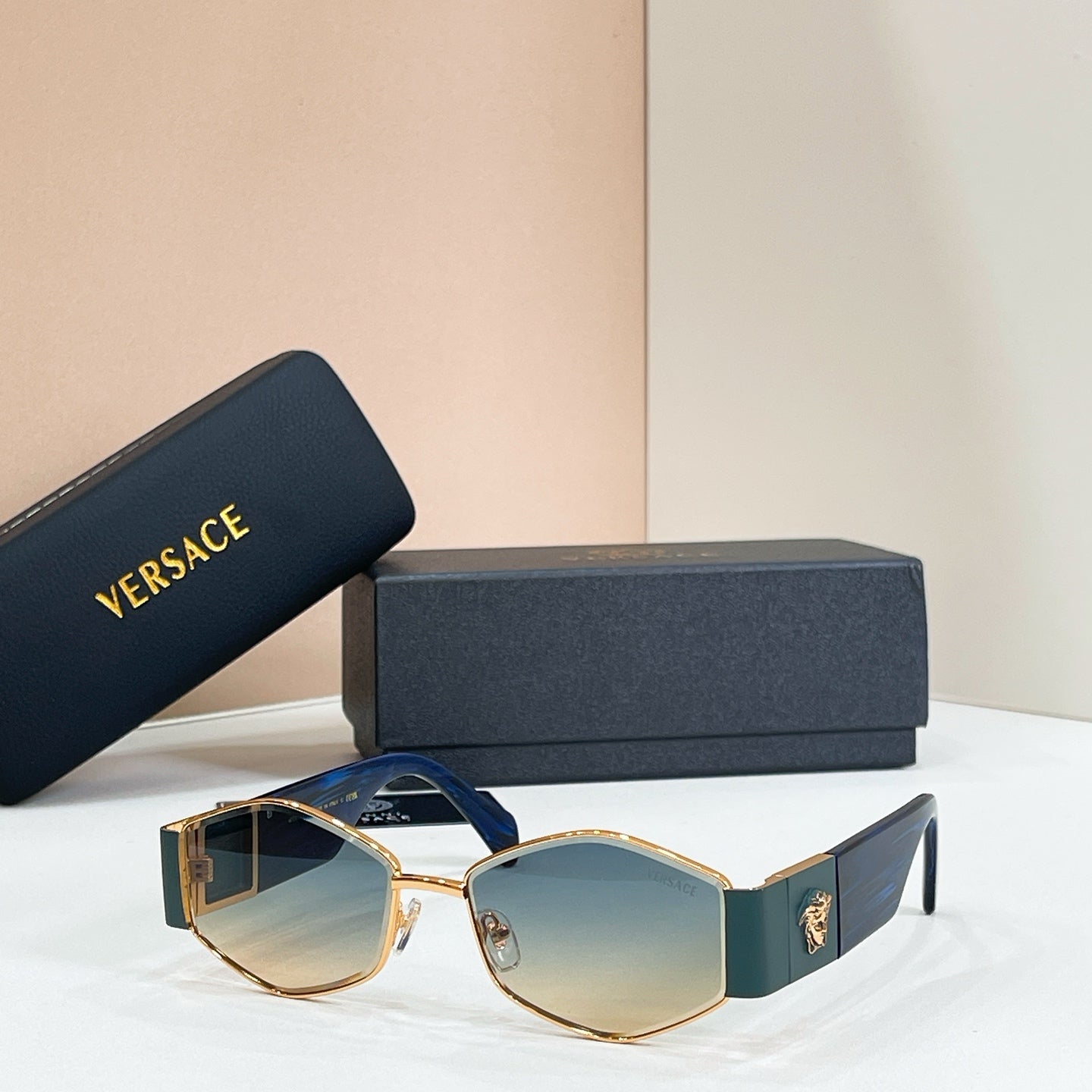 Versace octagonal sunglasses, gold frame with teal arms and light blue mirrored lenses