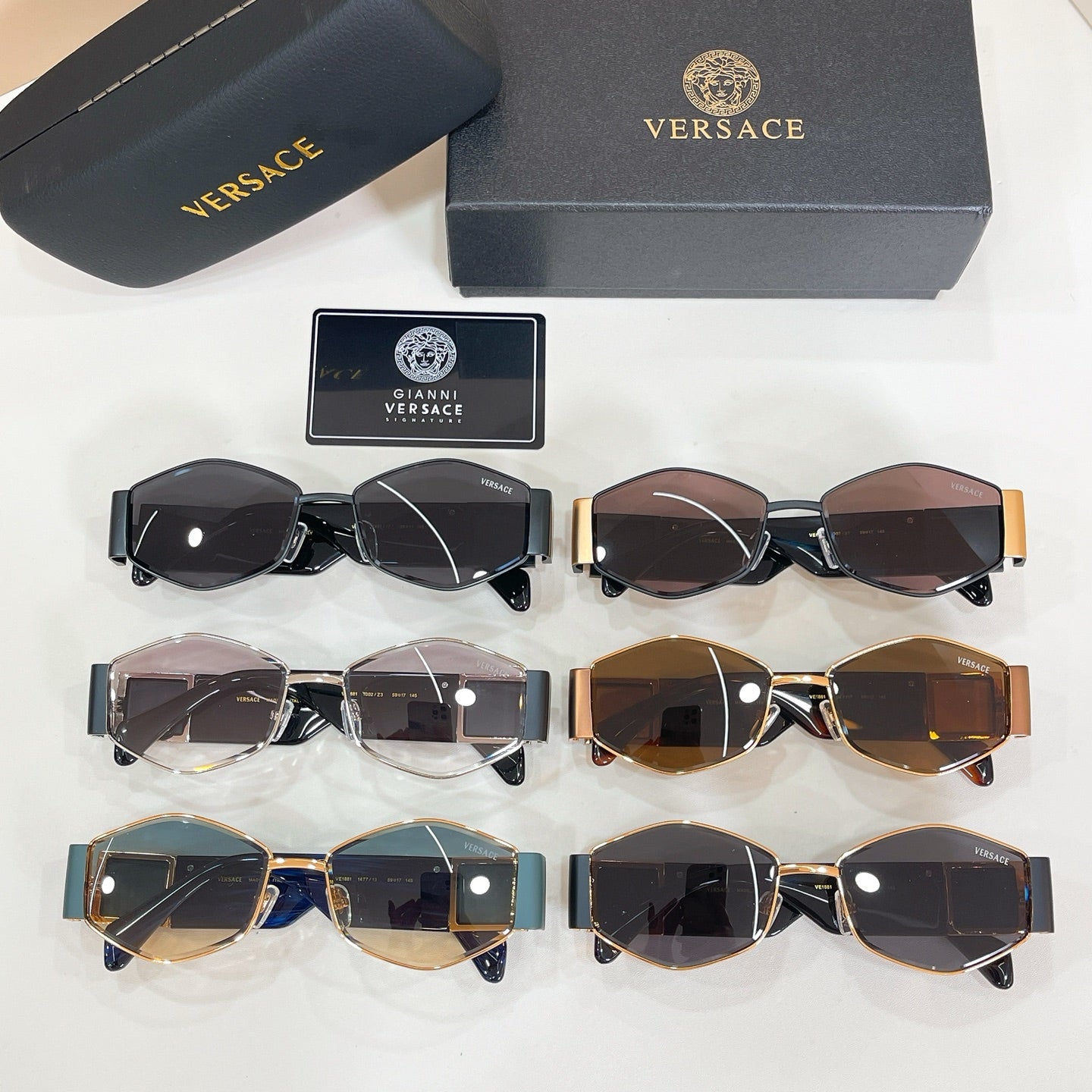 Versace sunglasses set in black, blue, brown, and gold frames with tinted lenses