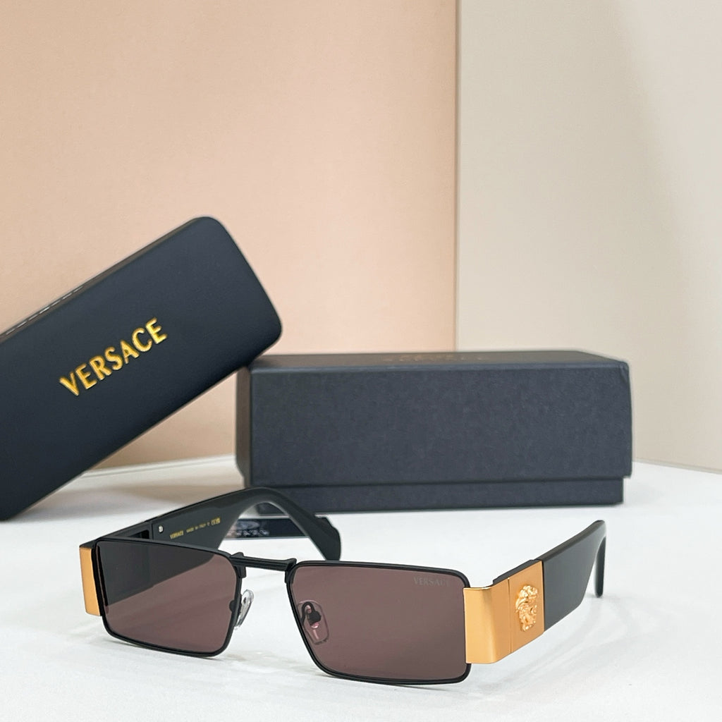 Rectangular sunglasses with dark frame and gold temple detail.