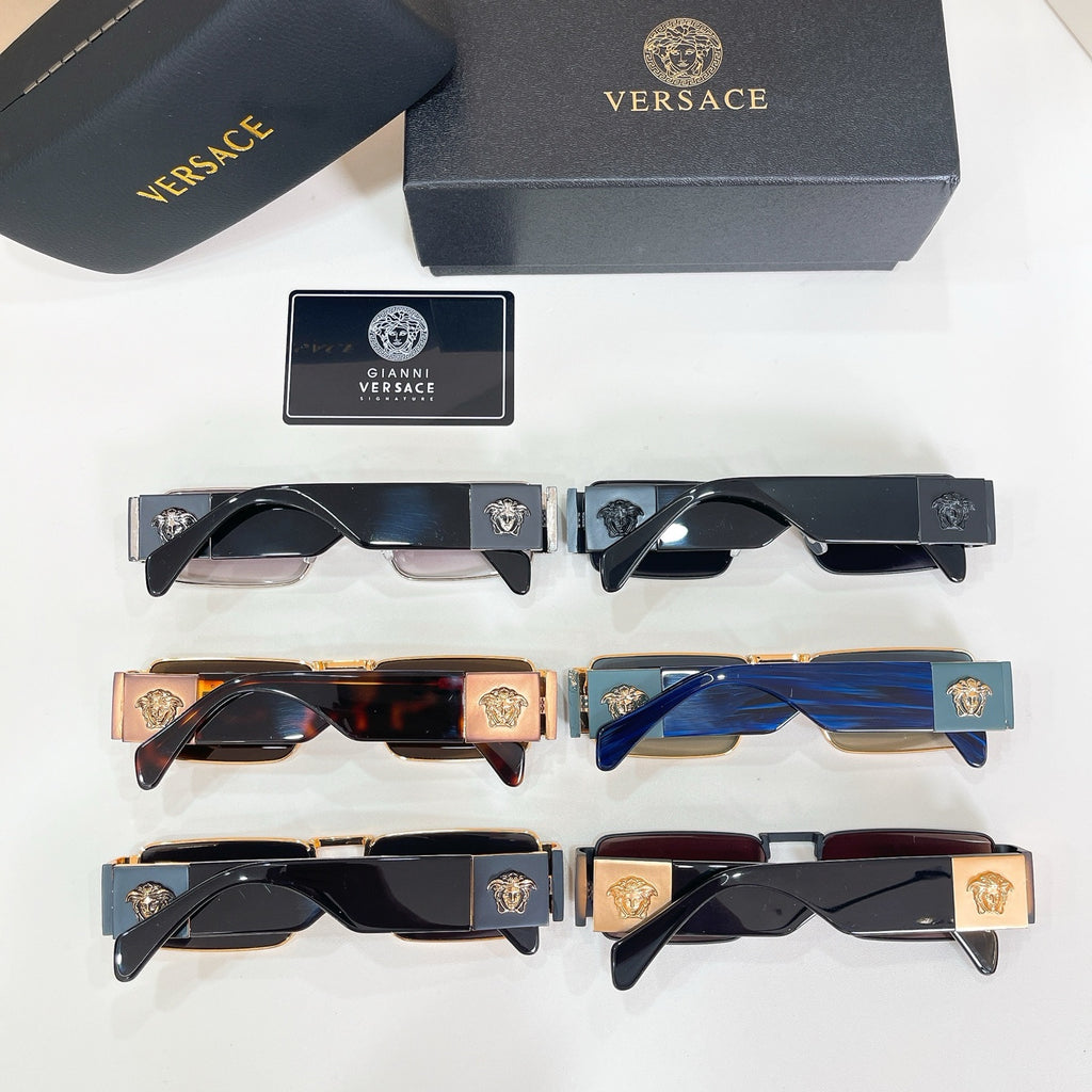 Assorted sunglasses with black, blue, and gold frames arranged in a grid.
