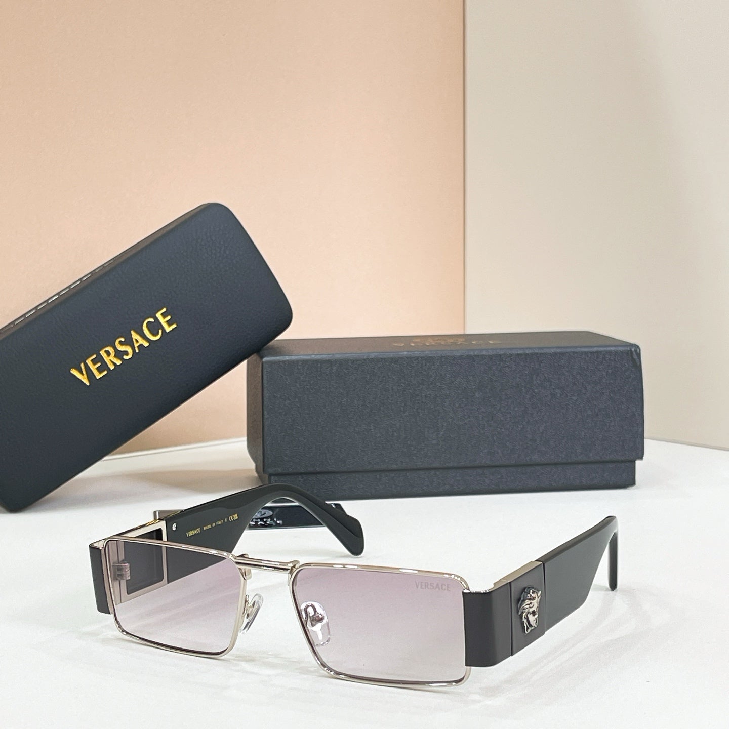 Rectangular sunglasses with silver frame and dark tinted lenses.