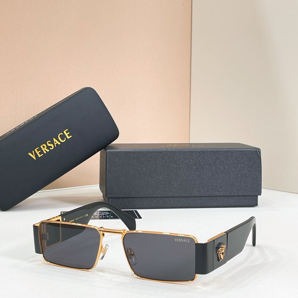 Rectangular sunglasses with gold frame and dark lenses with black temple accents.