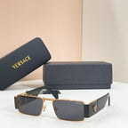 Rectangular sunglasses with gold frame and dark lenses with black temple accents.