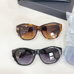 Tortoiseshell brown and black cat-eye sunglasses with tinted lenses, shown together.