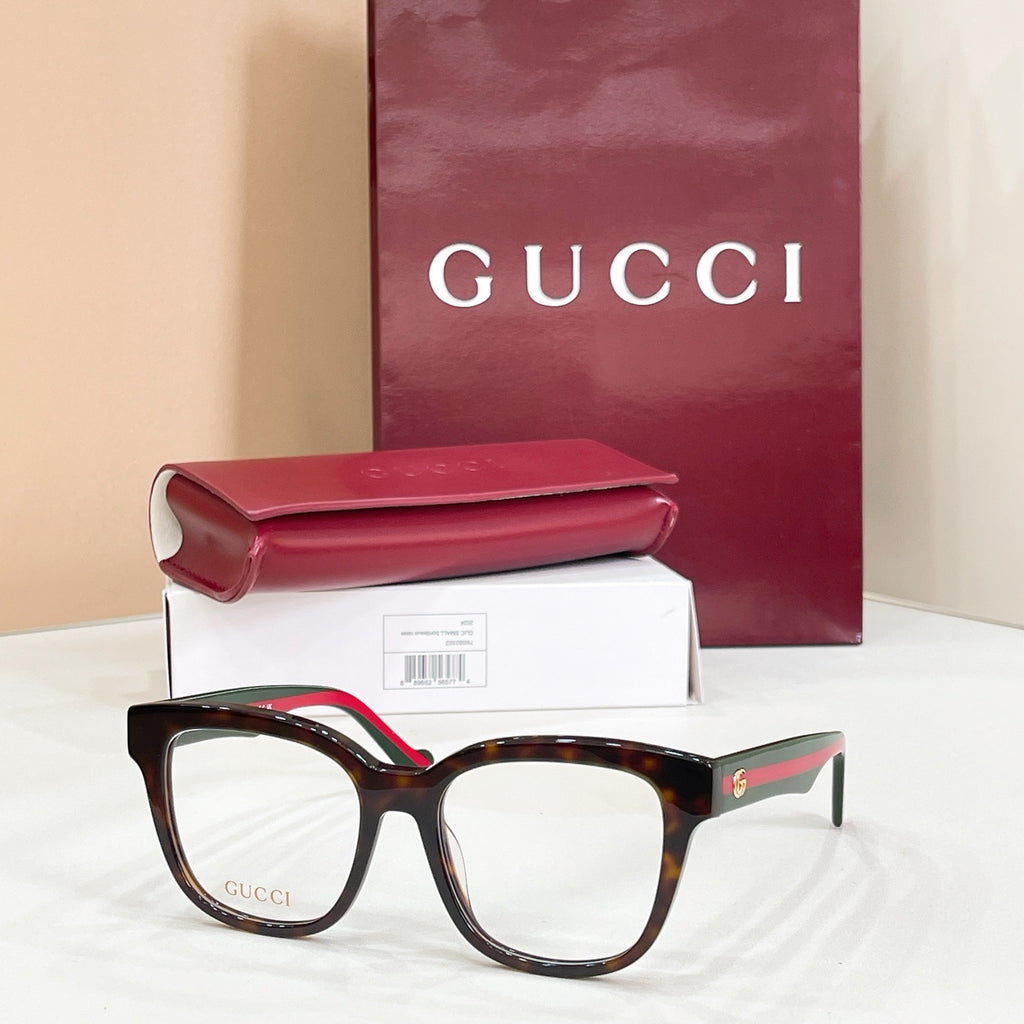 Gucci acetate glasses with dark tortoise frames, green temple detail, clear lenses
