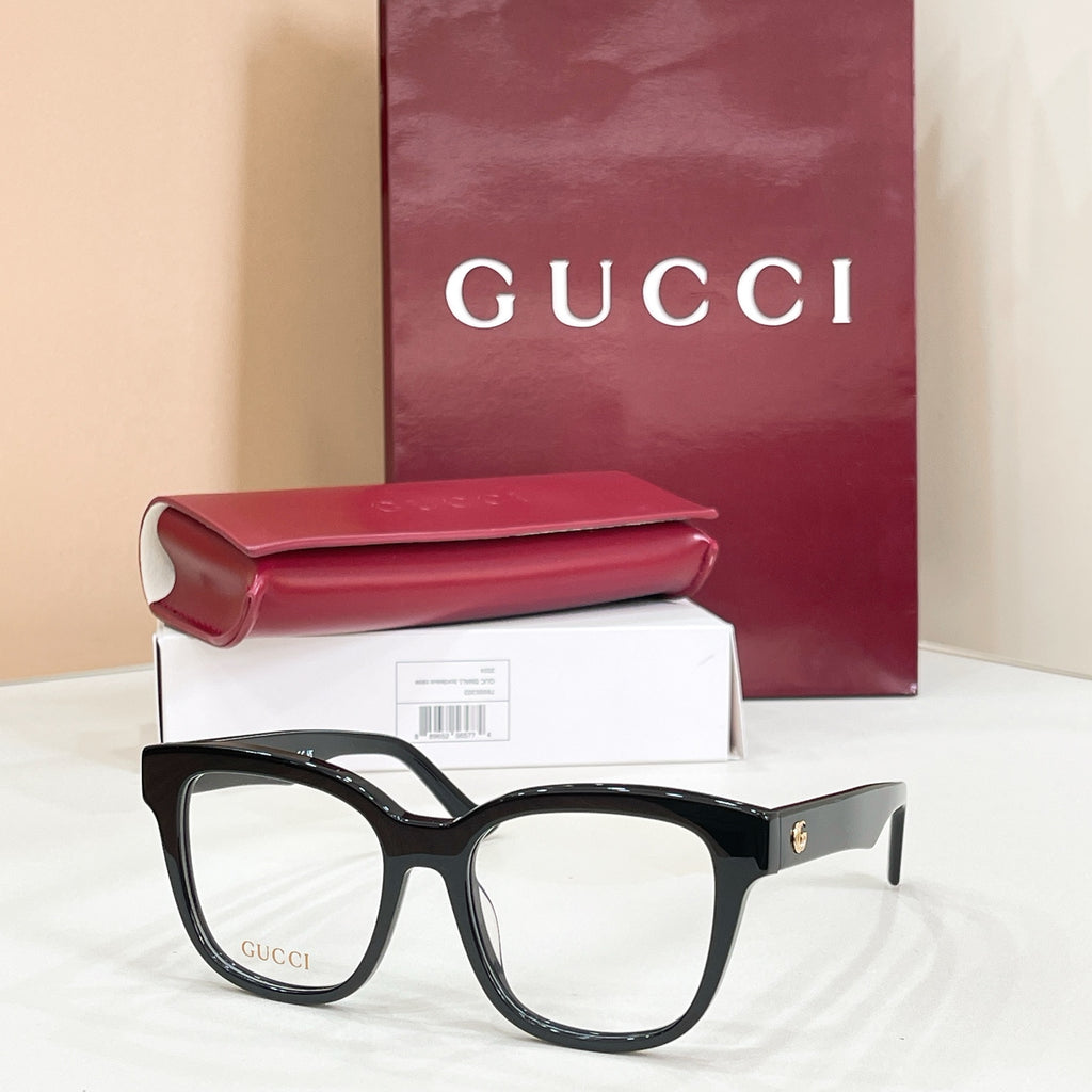 Gucci acetate glasses with dark tortoise frames and gold logo on temple, clear lenses