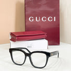 Gucci acetate glasses with dark tortoise frames and gold logo on temple, clear lenses
