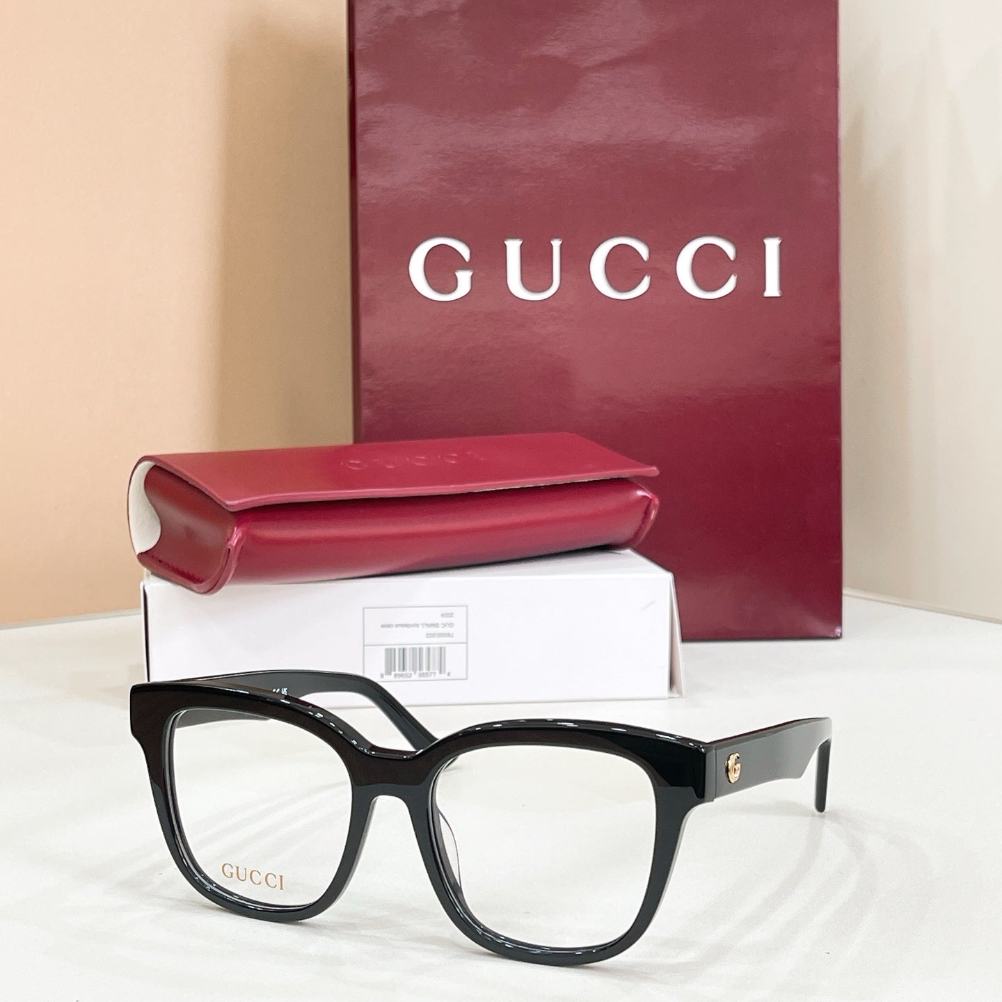 Gucci acetate glasses with dark tortoise frames and gold logo on temple, clear lenses
