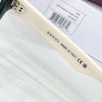 Gucci acetate glasses temple close-up with 'Made in Italy' text, clear lens
