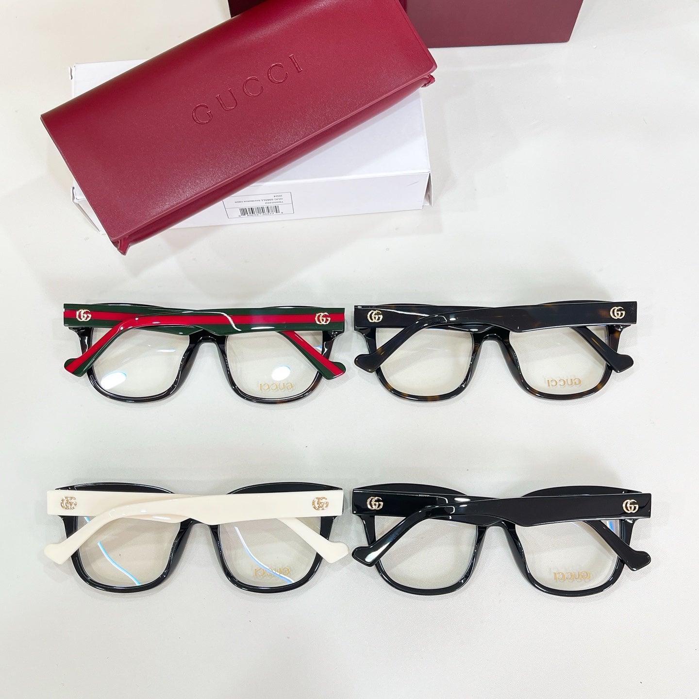 Gucci acetate glasses assortment of four pairs with black, tortoise, and red frames