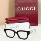Gucci eyeglasses with black frames and clear lenses, multicolor red-green temple accents