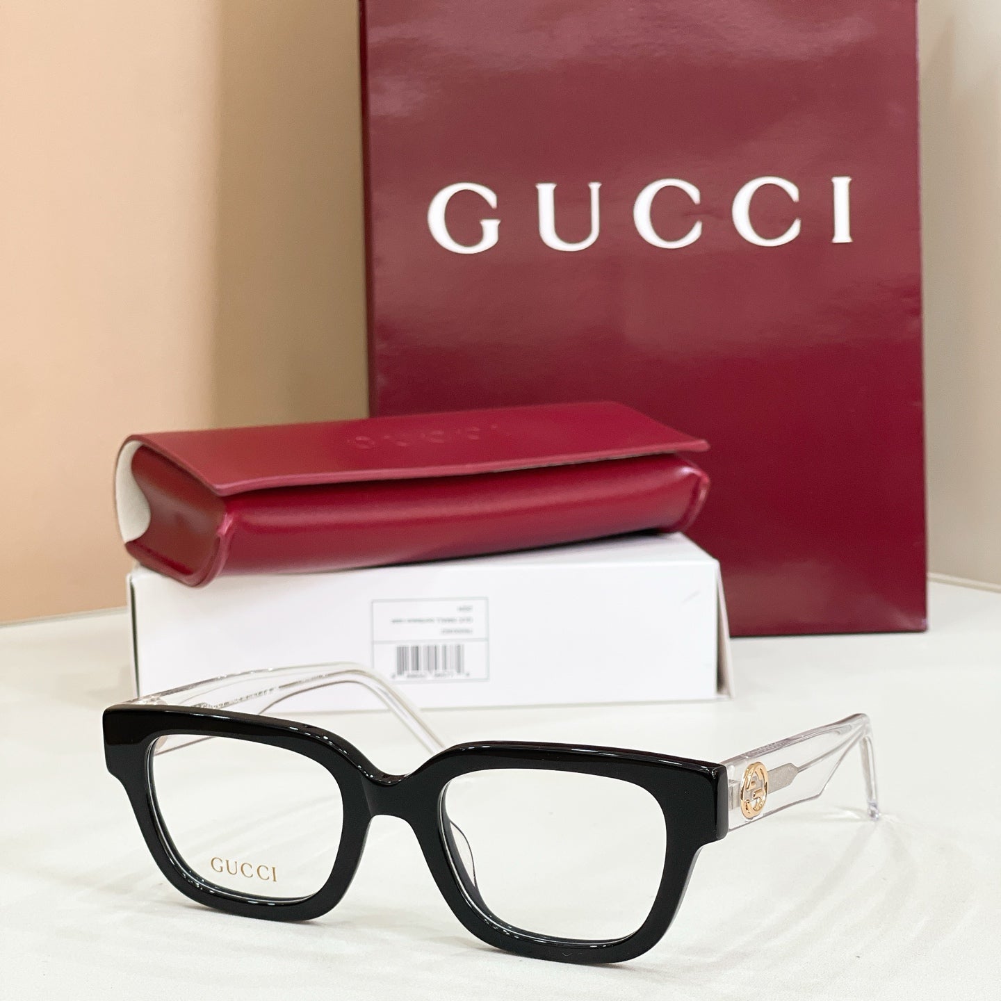 Gucci eyeglasses with black frames and clear lenses, multicolor red-green temple accents