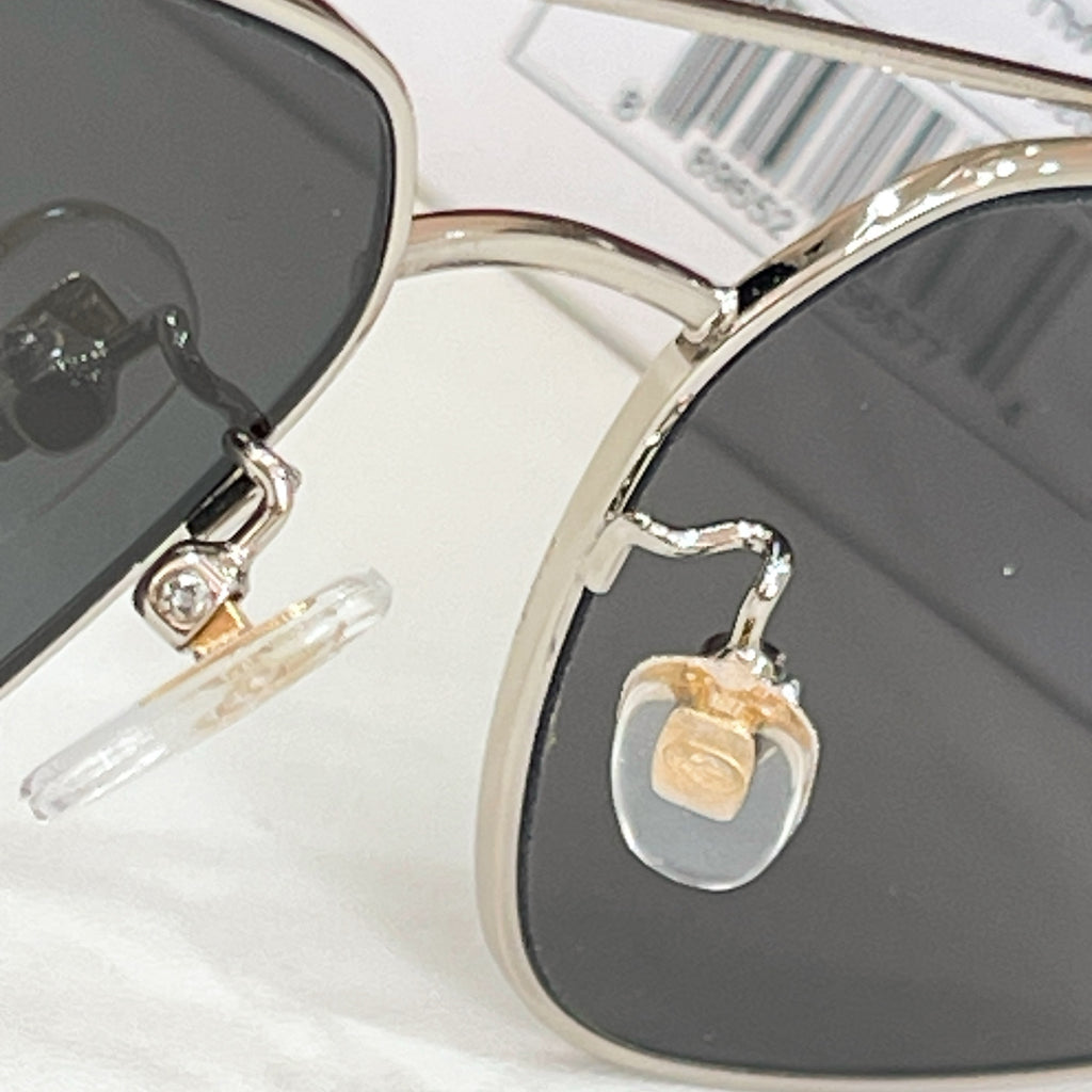 Gucci sunglasses close-up of hinges with gold-tone hardware and dark lenses