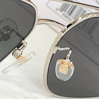 Gucci sunglasses close-up of hinges with gold-tone hardware and dark lenses