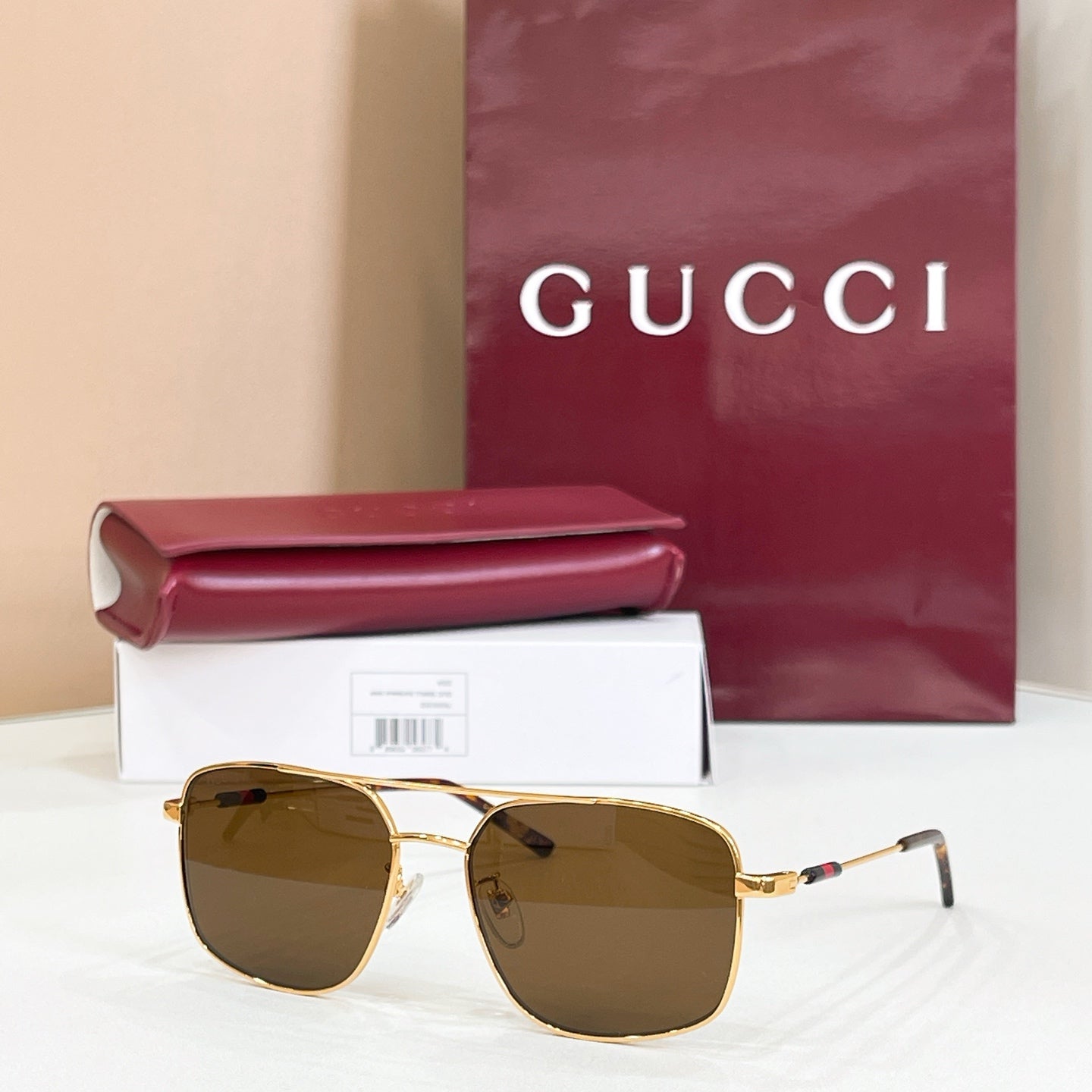 Gucci sunglasses with gold-tone frame and brown tinted lenses