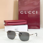 Gucci sunglasses with dark frame and gray tinted lenses