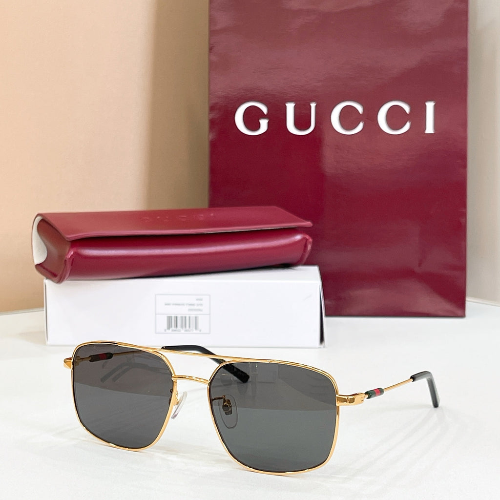 Gucci sunglasses with gold-tone frame and dark tinted lenses